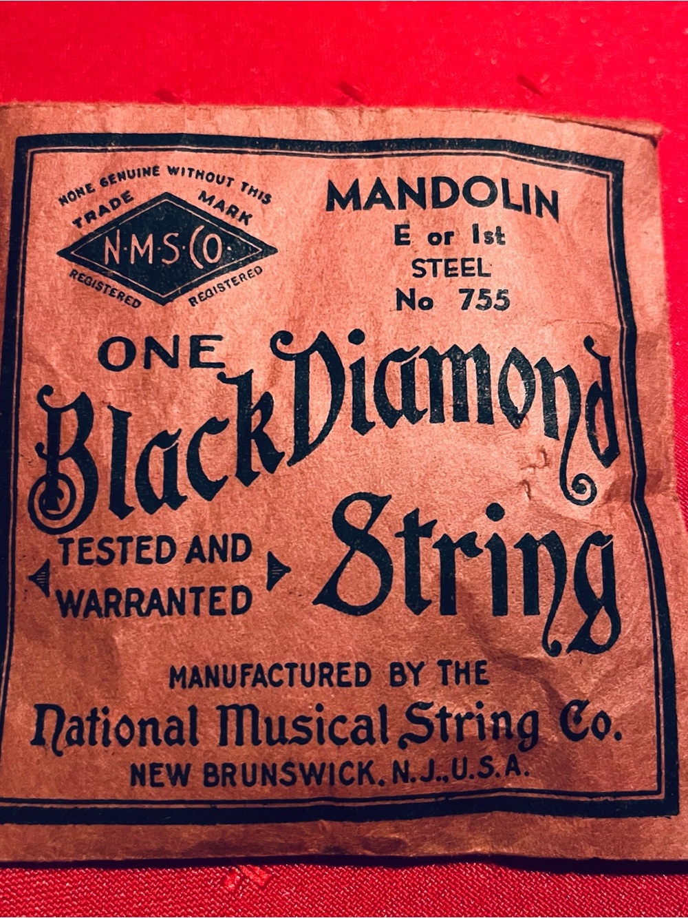 Black Diamond Red Logo on Cream Paper with Black Strings